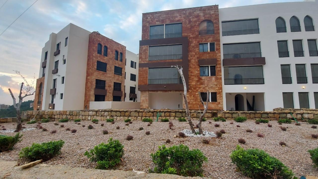 Landscaped gravel gardens beneath the stone facades at dusk