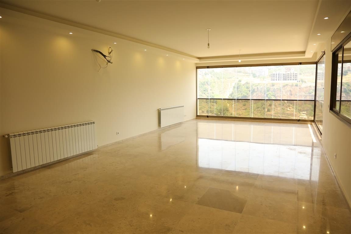 Marble-floored living and dining space with valley views