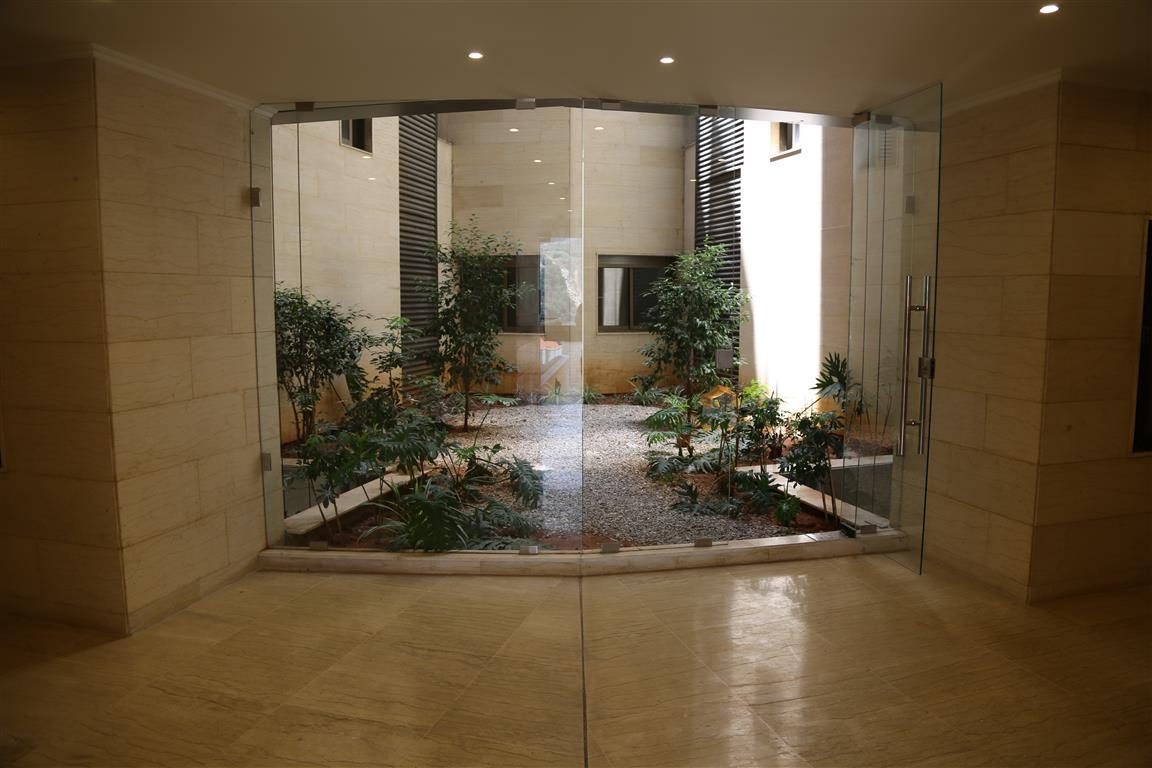 Glass-walled planted garden in the entrance lobby