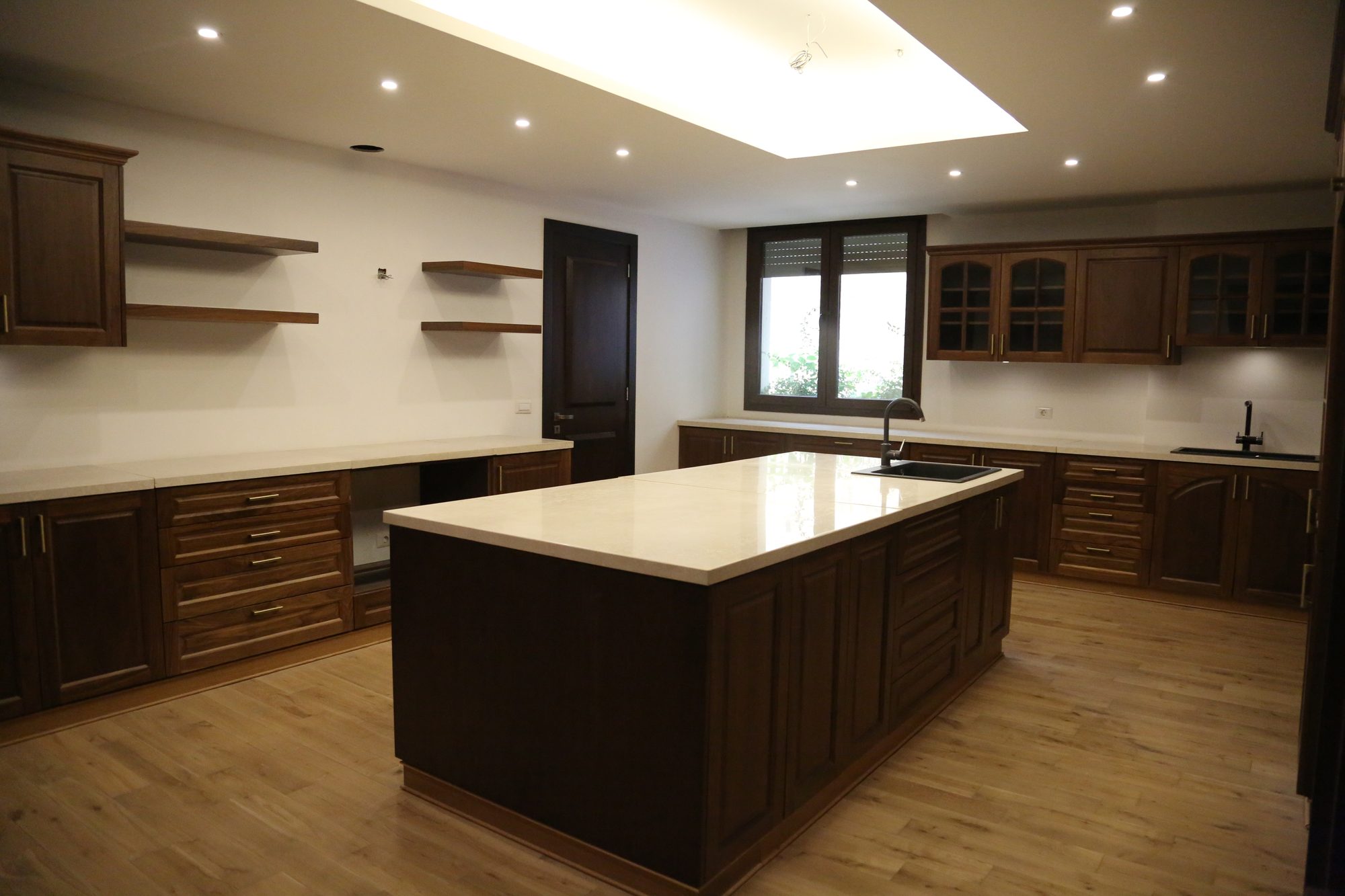 Solid wood kitchen with marble island and skylight