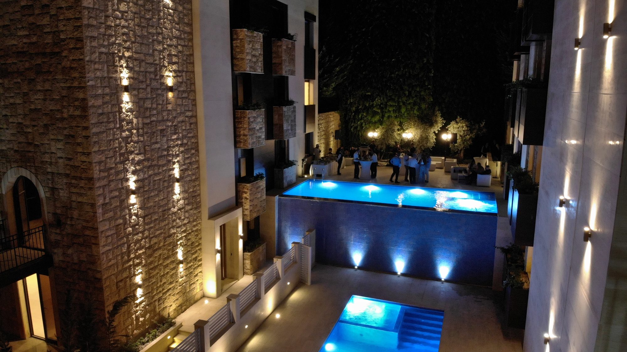 The lit pools between the two mansions of the Yarzeh Townhouses at night
