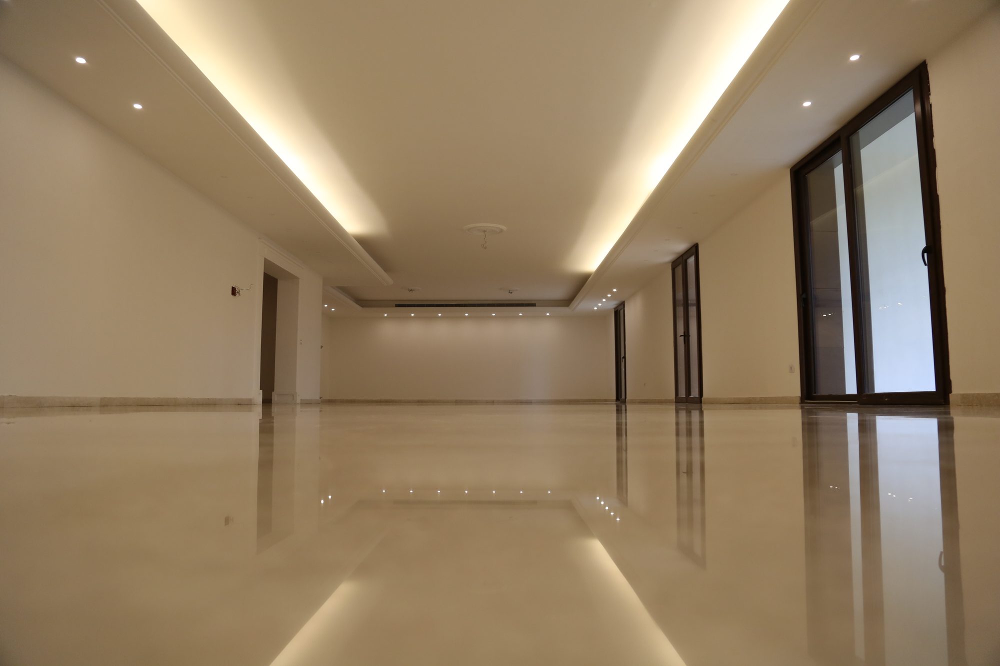 Grand marble salon with cove lighting
